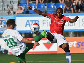 FC Edmonton's Sainey Nyassi, right, and New York Cosmos' Jimmy Mulligan battle for the ball during NASL action at Clarke Stadium on Saturday. (Ed Kaiser)