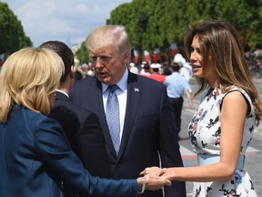 French President Emmanuel Macron, second left, and his wife Brigitte Macron, left, bid farewell to U.S President Donald Trump and First Lady Melania Trump after the Bastille Day military parade on the Champs Elysees avenue in Paris Friday, July 14, 2017.  (Christophe Archambault, Pool via AP)