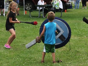 Finn MacDonald, 5, defends against his sister Lola, 8, and Addison Gilmore, 4, at the demonstration for the Sarnian Warband Club at Hobbyfest in Centennial Park Sunday. The new Belegarth club involves medieval combat using foam weaponry. Tyler Kula/Sarnia Observer/Postmedia Network