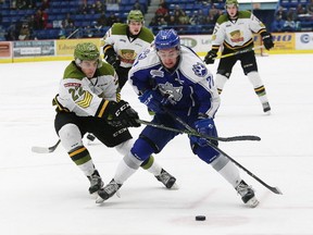 David Levin, right, of the Sudbury Wolves, tries to get around Brady Lyle, of the North Bay Battalion, during OHL action at the Sudbury Community Arena in Sudbury, Ont. on Friday February 17, 2017. John Lappa/Sudbury Star/Postmedia Network