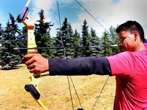 Sheldon Buffalo gets some practice shots before the Archery competition at the 2015 Alberta Indigenous Games at Hermitage Park in Edmonton, Alta., on Wednesday July 15, 2015. (Postmedia files)
