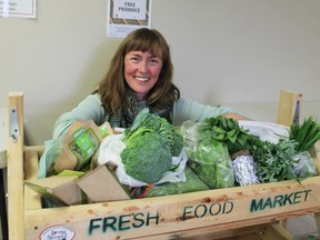 Lilith Wyatt, food access co-ordinator with Loving Spoonful, at the fresh food market stand at the Salvation Army on Patrick Street on Friday. (Steph Crosier/The Whig-Standard)