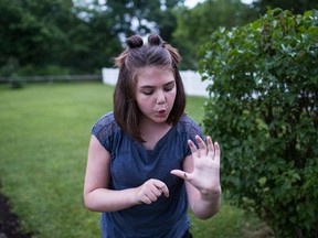 Emily Whitehead catches fireflies in her backyard in Pennsylvania. (Sean Simmers/The Washington Post)