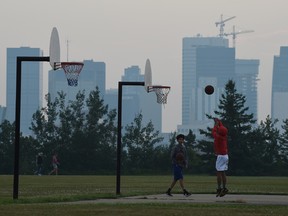 Smoke from the B.C. wildfires is blanketing Edmonton once again as boys play basketball in Forest Heights Park, July 16, 2017. Ed Kaiser/Postmedia