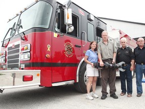 From the left, owners of Progressive Turf Equipment Inc. Bonnie and Luke Janmaat, Huron East Fire District Chief for the Seaforth area, Tom Phillips District and Deputy Chief, Doug Anstett.  The Janmaat’s recently gave a substantial amount of money; both are holding the Storm Series battery powered extrication tool that was purchased from their donations. (Shaun Gregory/Huron Expositor)
