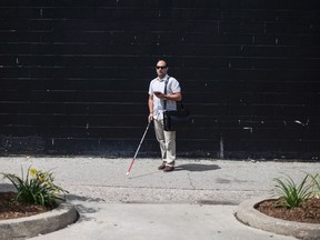 Mark DeMontis is pictured in Toronto's Yonge and St.Clair neighbourhood on Friday, July 14, 2017. The CNIB is planning to introduce 'Beacons' into stores and restaurants in the neighbourhood which will provide visually impaired customers, via an app the floor layout and other practical information of the premises they are entering. (THE CANADIAN PRESS/Chris Young)