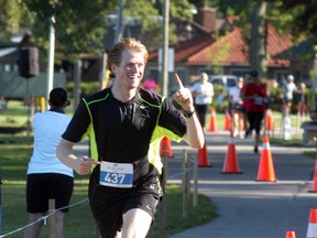 Brights Grove's Michael Kirkland smiles and shows who is in first place at Saturday's St. Clair River Run. Kirkland won the 10-kilometre division. (David Gough/Postmedia Network)