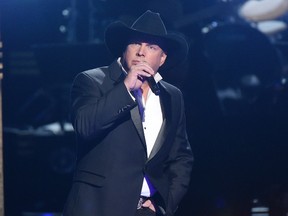 In this Nov. 2, 2016 file photo, Garth Brooks performs at the 50th annual CMA Awards in Nashville, Tenn. Brooks offered to pay for a Hawaiian honeymoon for a couple that got engaged at his Oklahoma City concert on July 15, 2017. (Photo by Charles Sykes/Invision/AP, File)