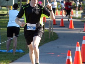 Brights Grove's Michael Kirkland smiles and shows who is in first place at Saturday's St. Clair River Run. Kirkland won the ten kilometre division.
