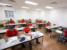 Students study heating and cooling systems at North American Trade Schools in London. (DEREK RUTTAN, The London Free Press)