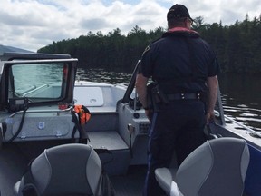 Members of the marine unit out of the North Bay OPP detachment scour the Ottawa River near Mattawa for the body of a swimmer presumed drowned. (Photo supplied)