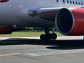 In this photo taken from the twitter feed of passenger Mike Gibson, a view of the blown tire of an Air Canada plane which abandoned flight, at London Gatwick , Monday, July 17, 2017. A flight from London to Toronto carrying 282 passengers has been forced to turn back after one of its tires burst as it took off. (Mike Gibson via AP)