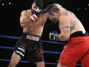 Adam Braidwood (L) fighting Tim Hague during the KO 79 boxing event at the Shaw Centre in Edmonton, June 16, 2017.