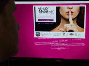 A man looks at the Ashley Madison website in this photo illustration in Toronto on Thursday, August 20, 2015. The Toronto-based parent company of the infidelity dating site Ashley Madison says it has reached a US$11.2-million settlement an American class-action lawsuits stemming from a massive security breach two years ago. THE CANADIAN PRESS/Graeme Roy