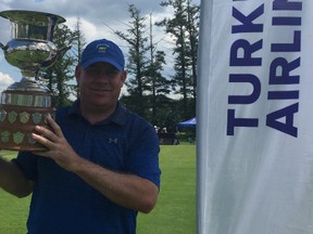 Robert Mackay shows off the Lord Alexander of Tunis trophy after winning the two-round evnet with a 4-under total of 140 at Rivermead, his home course, on Monday.