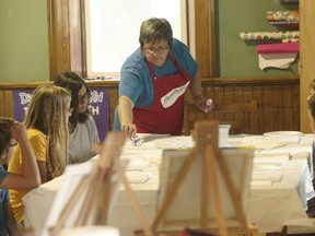 Brushstrokes In Motion owner, Heather DeJong taught about a dozen children at the Seaforth Library how to paint canvass drawings July 13. (Shaun Gregory/Huron Expositor)