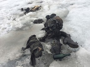 In this photo released by the Swiss train company ' Glacier 3000' shoes and clothing are visible at a Swiss glacier where two bodies were found. Police say the bodies of what appear to be two people killed in an accident decades ago have been recovered from a glacier in southwestern Switzerland. (GLACIER 3000/Keystone via AP)