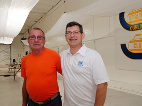 The Stirling Curling Club's bar chairman, John Parker, stands with Mike Bossio in the club Tuesday in Stirling. A newly-received federal grant is allowing the club to install video monitors for spectators and make other improvements designed to aid seniors.