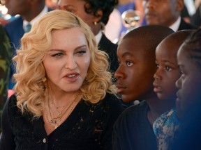 In this July 11, 2017 file photo, Madonna, left, sits with her adopted children David, Stella and Mercy, at the opening of The Mercy James Institute for Pediatric Surgery and Intensive Care. (AP Photo Thoko Chikondi, File)