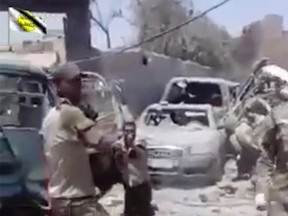 This file photo made from undated video posted online in July, 2017 shows a man in an Iraqi Army uniform moments before shooting an unarmed man in Mosul, Iraq. Vengeance is fueling a string of extrajudicial killings of Islamic State group militants amid the fall of Mosul. One Iraqi lieutenant says he has been hunting the past three years for the two IS members he believes killed his father, and he describes interrogating one man and then shooting him. A video shows troops throwing IS suspects to their deaths. Rights groups warn that such killings will only fuel recruitment for the next-generation militant group.(AP Photo, File)