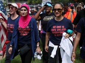 Activist Linda Sarsour, centre, and fellow gun-control activists participate in a march beginning at the headquarters of National Rifle Association on July 14, 2017 in Fairfax, Virginia. (Alex Wong/Getty Images)