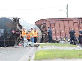 A CN freight train derailed in Strathroy, Ontario, about 4:30 a.m.  on Wednesday, July 19, 2017. The train went off the tracks between the crossings at Caradoc Street and Richmond Street in the middle of the town, leaving a wreckage-strewn crash scene that drew hundreds of curious onlookers. Nobody was injured, police said. (DALE CARRUTHERS, The London Free Press)