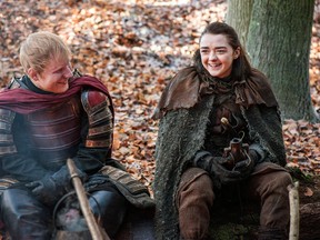 This image released by HBO shows Ed Sheeran, left, and Maisie Williams in a scene from "Game of Thrones." Sheeran appeared as a Lannister soldier leading a group in song in the season premiere of the hit HBO fantasy drama, which debuted on the premium cable channel Sunday night. (Helen Sloan/HBO via AP)