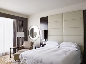 A standard Hilton hotel room in Panama. In the book, paired photos of interiors and window views are displayed on facing pages. (Roger Eberhard)