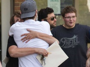 Workers at the closing Siemens wind turbine blade plant in Tillsonburg emerge from their meeting and say some goodbyes on Tuesday July 18, 2017. MIKE HENSEN / THE LONDON FREE PRESS/POSTMEDIA NETWORK