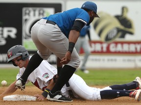 Winnipeg Goldeyes third baseman Wes Darvill slides safely into second base for a steal as St. Paul Saints second baseman Tony Thomas can't corral the ball during American Association baseball action at Shaw Park in Winnipeg on Wed., July 19, 2017. Kevin King/Winnipeg Sun