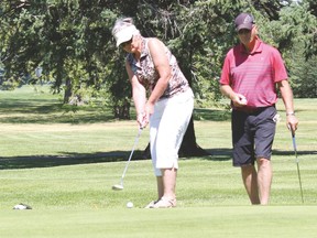 Hole in one. Wendy, left, tries her luck at the hole in one, with husband Jack Williams standing beside her. Couple is from Arrowwood.