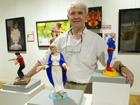 R. Bruce Flowers displays three Wannabes made by artist Jane Hook. The Wannabes are portraits of an imagined history featuring a female Elvis, a Librarian Virgin Mary and a naturopath Superman, all cast in polyurethane and part of the Pride London Art show at the Arts Project in London.(MIKE HENSEN, The London Free Press)