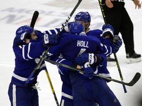 Toronto Marlies defenceman Justin Holl is mobbed after scoring an overtime goal against the Albany Devils in AHL playoff action on April 28, 2017. (Jack Boland/Toronto Sun/Postmedia Network)