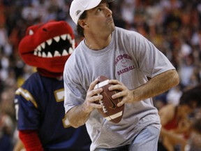 Retired Argos quarterback Doug Flutie fires an autographed ball into the 300 level of the Air Canada Centre during a break in action at an NBA game on Jan. 5, 2007. (Postmedia)