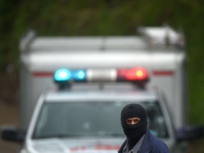 A police officer arrives to a crime scene in San Salvador.