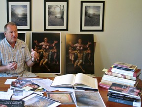 In this June 26, 2017 photo, Martin Kober displays literature and copies of a family heirloom that he believes was painted by Renaissance master Michelangelo, at his home in Tonawanda, N.Y. Kober is convinced the painting of a dying Jesus that hung above the mantel in his upstate New York childhood home is the work of Michelangelo. Getting experts to agree remains the $300 million hurdle. (AP Photo/Carolyn Thompson)