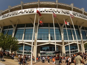 In this Sunday, Sept. 13, 2009 file photo, fans walk into Cleveland Browns Stadium before the Minnesota Vikings play the Cleveland Browns in an NFL football game, in Cleveland. In sales brochures, a U.S. company boasted of the "stunning visual effect" its shimmering aluminum panels created in an NFL stadium, an Alaskan school and a 33-story hotel on Baltimore's waterfront.(AP Photo/Tony Dejak, File)