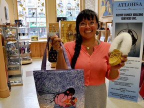 Lorna Chrysler, social enterprise manager with Atlohsa Native Family Healing Services, holds a couple items at Atlohsa Gifts. The new social enterprise opened June 21 and benefits numerous programs and services at Atlohsa. (CHRIS MONTANINI, Londoner)