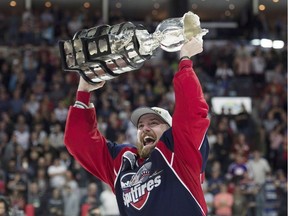 Windsor Spitfires centre and Kingston native Aaron Luchuk, who scored the game-winning goal, raises the trophy after the Spitfires beat the Erie Otters to win the Memorial Cup in Windsor on May 28. (Adrian Wyld/The Canadian Press)