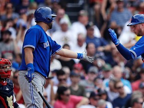 Toronto Blue Jays' Justin Smoak is congratulated by Kendrys Morales after his solo home run during the fifth inning of a baseball game against the Boston Red Sox at Fenway Park on July 20, 2017. (AP Photo/Charles Krupa)