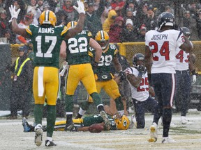 In this Dec. 4, 2016, file photo, Green Bay Packers' Randall Cobb makes a snow angel after catching a touchdown pass during the first half of an NFL football game against the Houston Texans, in Green Bay, Wis. (AP Photo/Mike Roemer, File)