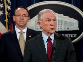 Attorney General Jeff Sessions, accompanied by Deputy Attorney General Rod Rosenstein, left, speaks at a news conference to announce an international cybercrime enforcement action at the Department of Justice, Thursday, July 20, 2017, in Washington. (AP Photo/Andrew Harnik)