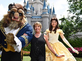 In this handout photo provided by Disney Parks, actress, singer, artist and Disney Legend Paige O'Hara strikes a royal pose with Belle and Beast while vacationing at Magic Kingdom Park, Walt Disney World Resort June 1, 2017 in Lake Buena Vista, Florida. (Chloe Rice/Disney Parks via Getty Images)