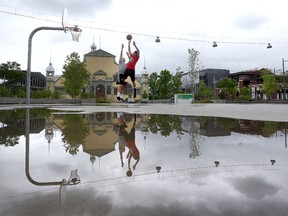 Jake Dicks and Jorell Izaguirre play basketball after a rainy day at Lansdowne Park in Ottawa Friday May 26, 2017.