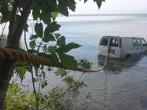 Van sits in Lake Erie on July 21, 2017 after it was driven off a cliff at the end of Baldwin Road south of County Road 50 in Essex. (Jason Kryk/Windsor Star)