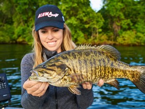 Columnist Ashley Rae with a beautifully coloured Lake Ontario smallmouth bass. She caught it using a swimbait. (Submitted photo)