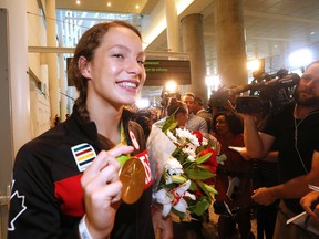 Canadian swimmer Penny Oleksiak arrives at Pearson Airport near Toronto on a flight from Rio de Janeiro following the Summer Olympics on Aug. 23, 2016. (Michael Peake/Toronto Sun)