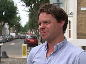 In this photo taken from video footage, Andre Spicer, father of five-year-old girl who was stopped by council officers from selling home-made lemonade, talks to a reporter in London, Friday, July 21, 2017. A British man and his young daughter have gained international attention for being fined 150 pounds ($195) for selling lemonade without a license near their home in London. (ITN via AP)