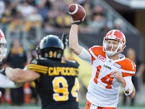 BC Lions quarterback Travis Lulay (14) throws during first-half CFL action against the Hamilton Tiger-Cats in Hamilton, Ont., on Saturday, July 15, 2017. THE CANADIAN PRESS/Peter Power