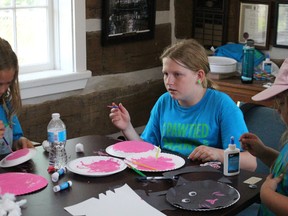 Bryn Desjardine, left, and Makenna Zavitz try some crafts during the Humane Society's Critter Camp. (NEIL BOWEN/Sarnia Observer)